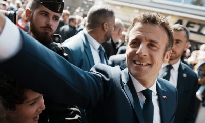 Emmanuel Macron shakes hands with well-wishers