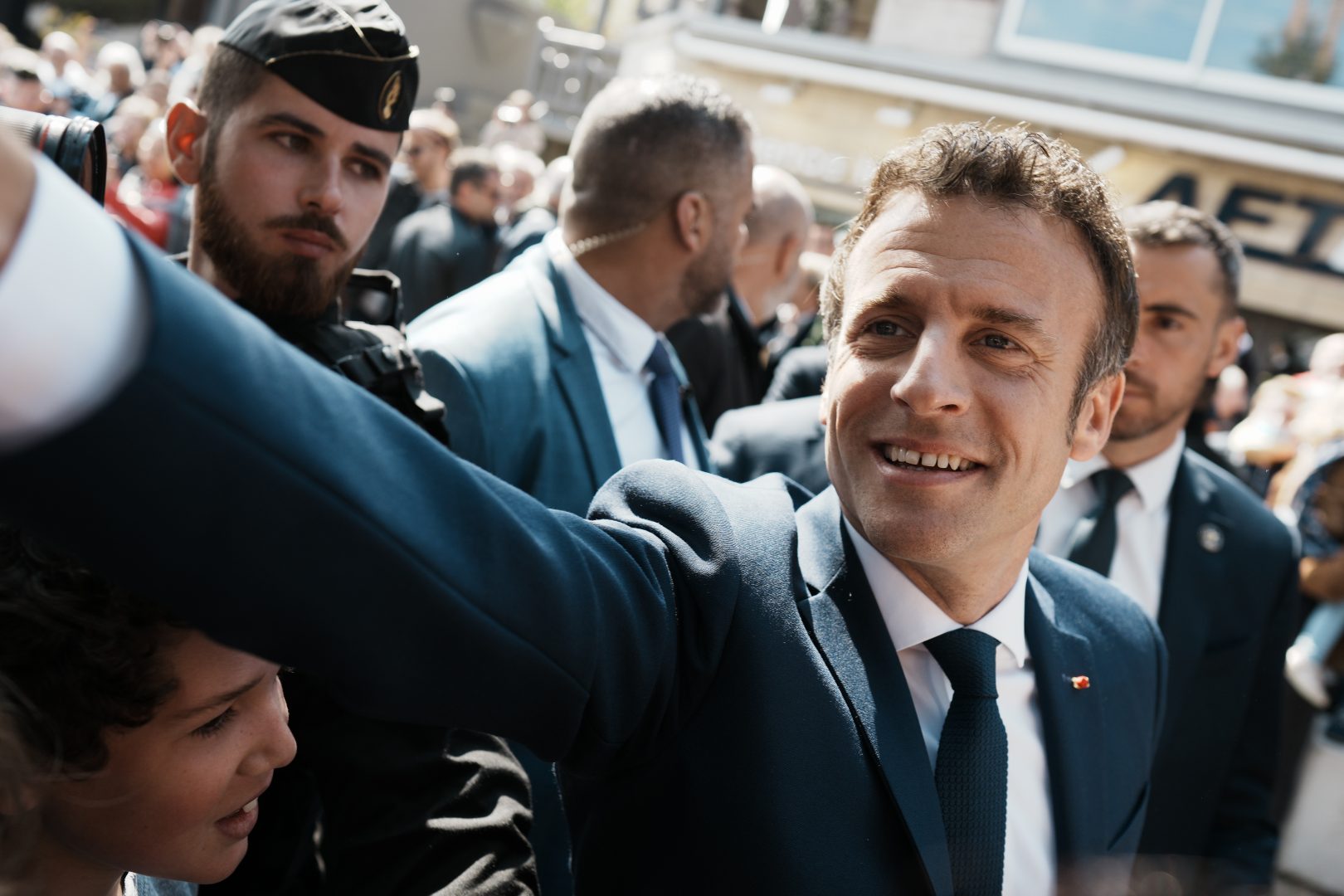 Emmanuel Macron shakes hands with well-wishers